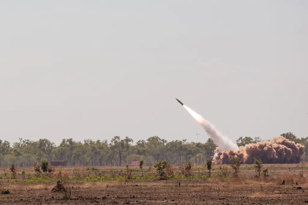 US Army field artillery unit launching an ATACMS missile from a ground vehicle during a training exercise